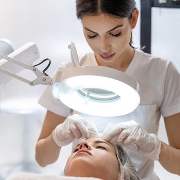 Skin,Treatment,,Beautician,Squeezing,Pimples,From,Face,Of,Young,Female.