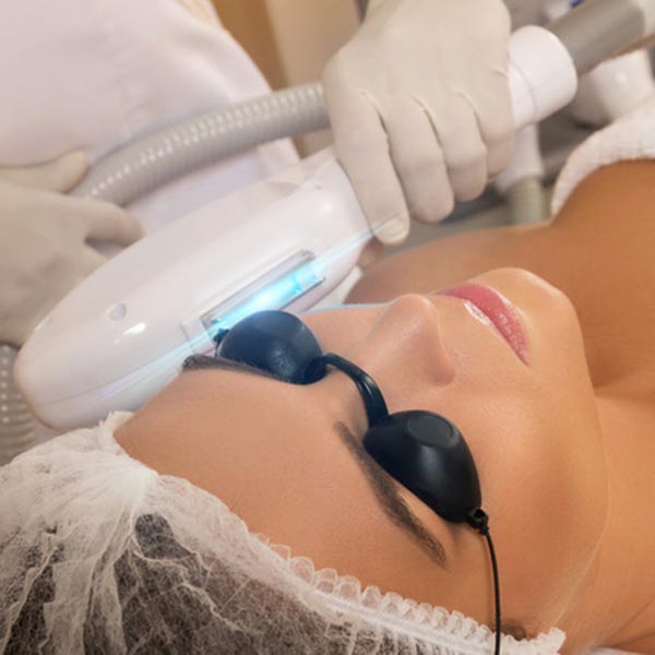 Beautiful woman in professional beauty salon during photo rejuvenation procedure